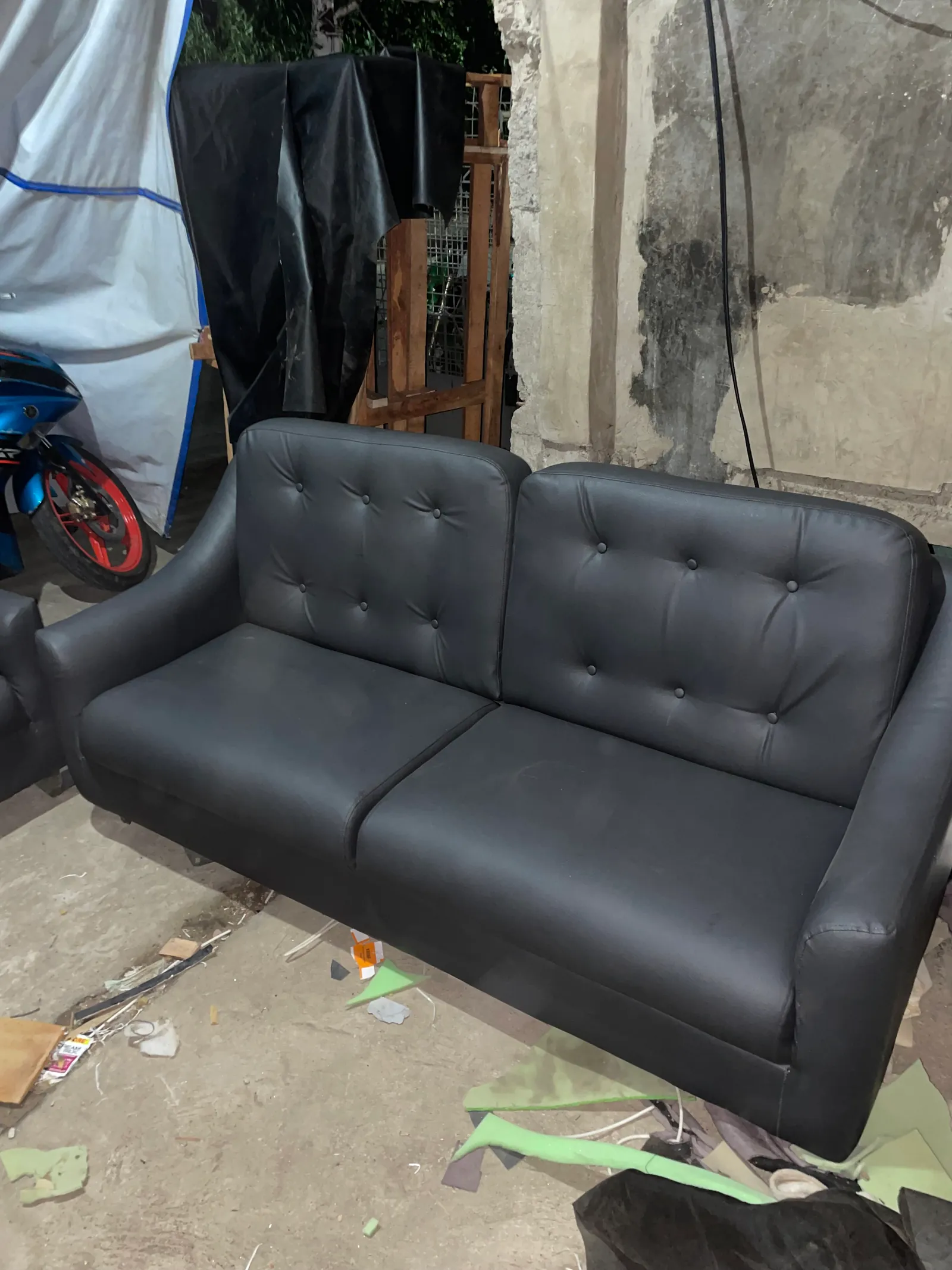     Charcoal gray 2-seater sofa side perspective with padded armrests