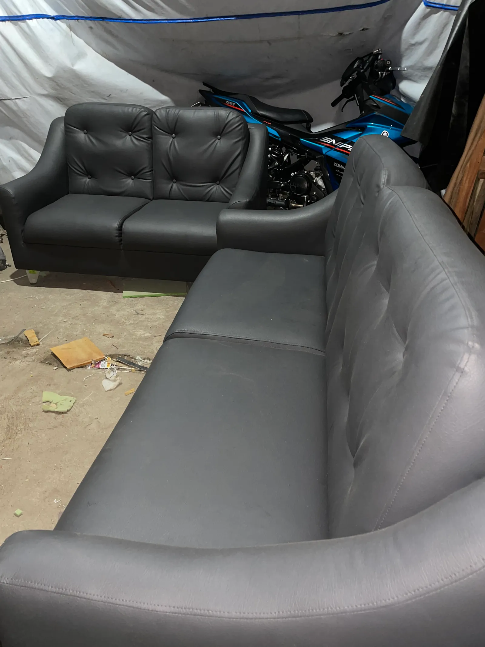     Charcoal gray button tufted 2-seater sofa left angle view