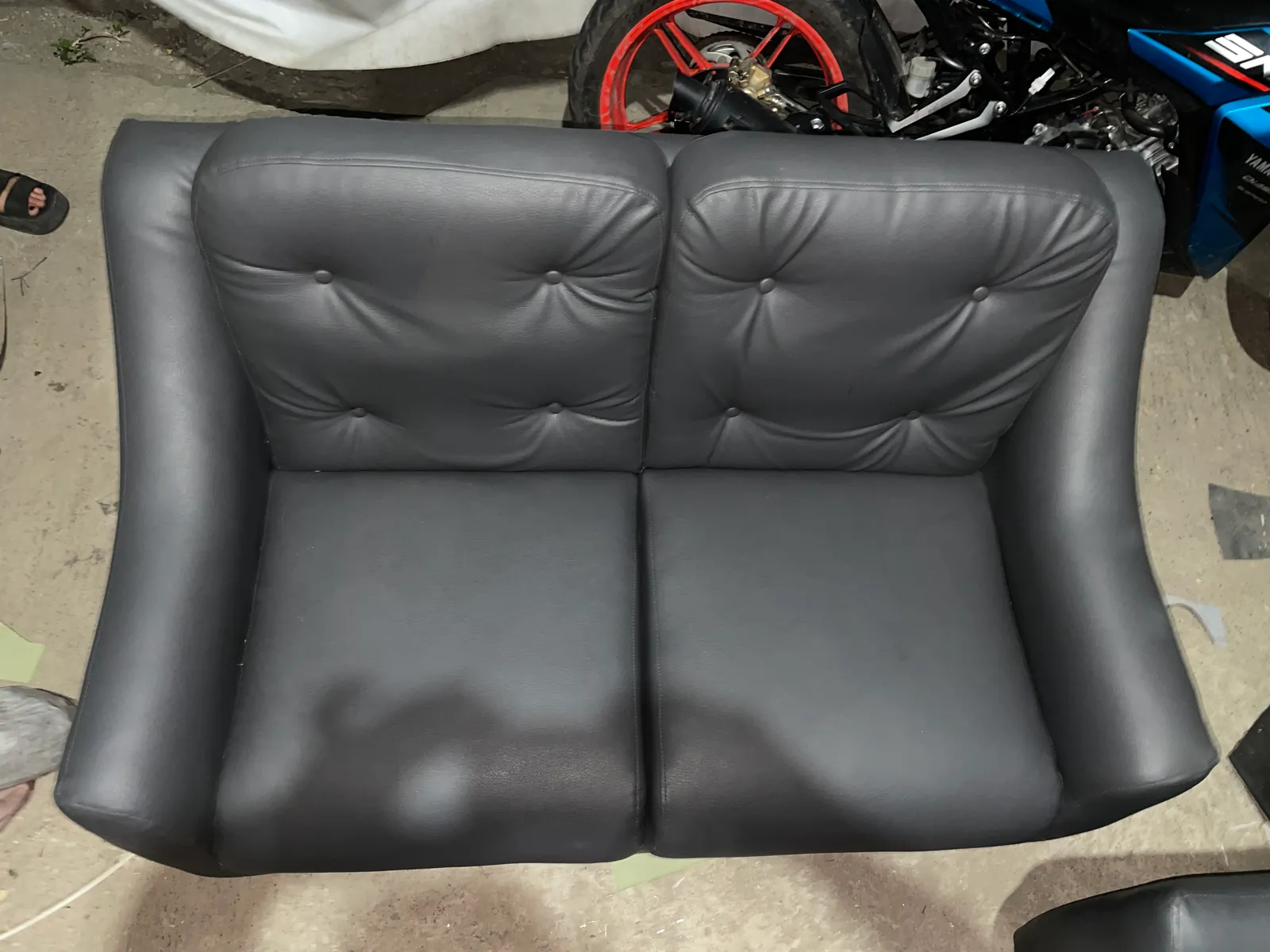 Charcoal gray 2-seater button tufted leatherette sofa top view